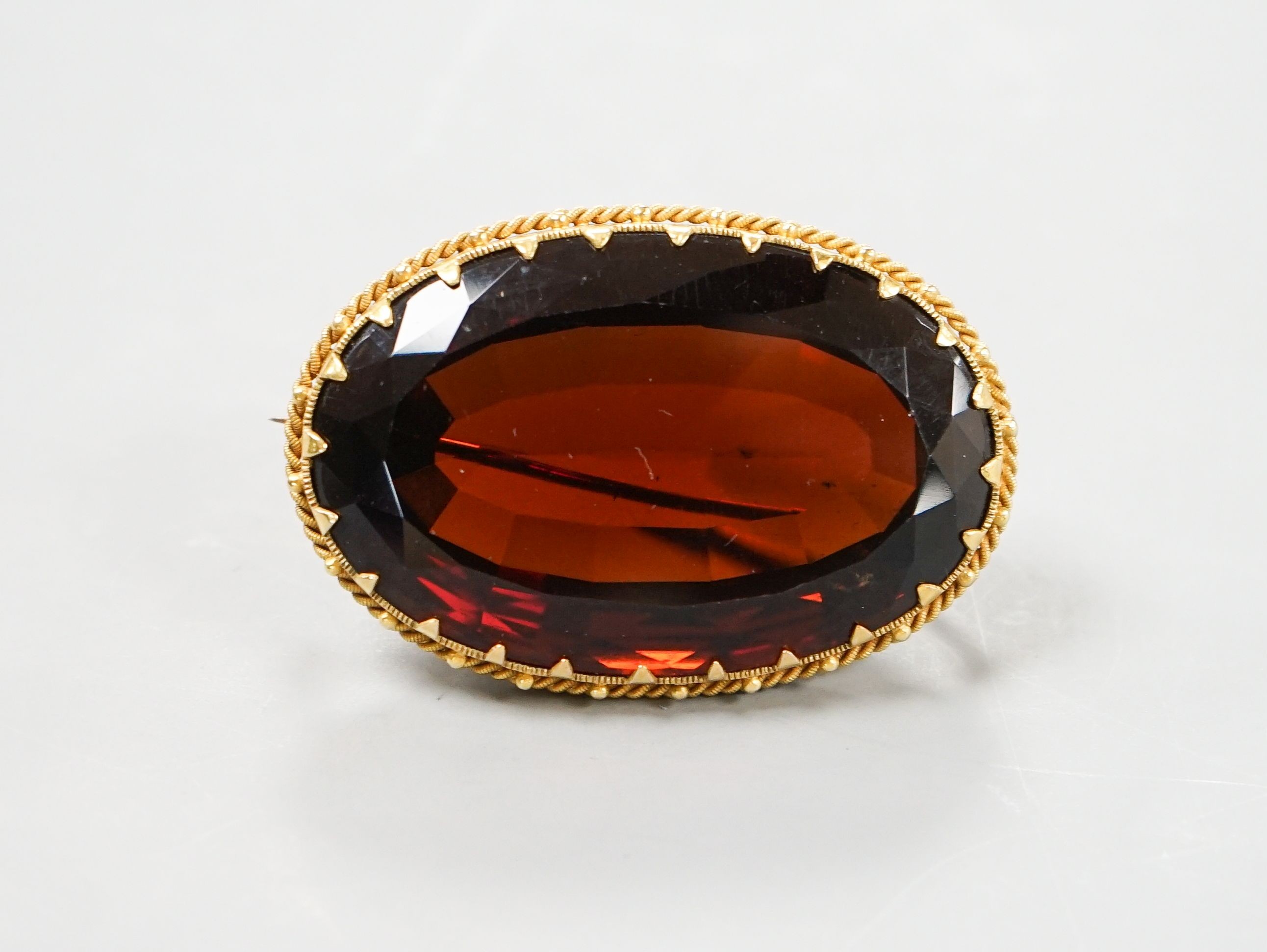A large yellow metal mounted dark citrine brooch, 48mm, gross weight 37.9 grams.